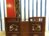 a dresser with a mirror on top of it in front of a striped wall