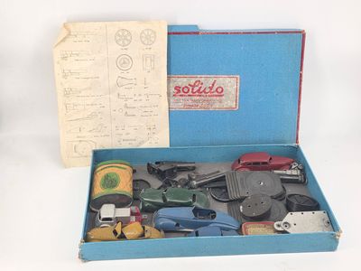 a blue box filled with assorted items on a white surface