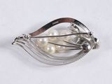 silver plated brooch with white pearls and a wooden handle
