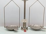 a metal scale with a red object on top of it