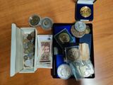 a box full of coins and other items on a table