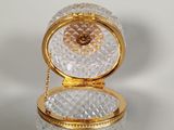 a gold and crystal box with a chain around it