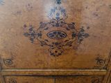 an old wooden cabinet with a decorative design on it