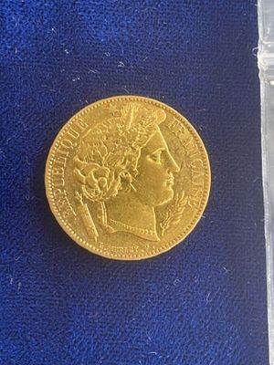 a gold coin sitting on top of a blue cloth
