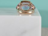 a close up of a gold ring with a blue stone on top