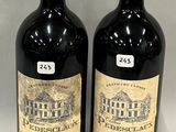 two bottles of wine sitting next to each other on a table