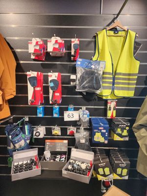 many items on display in a store that include safety vests and safety vests