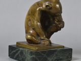 bronze sculpture of a monkey sitting on a marble base