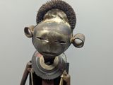 a metal sculpture of a man with a hat on his head