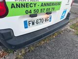a white van with a green sticker on the back of it