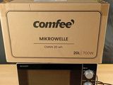 a microwave sitting on top of a box on a table