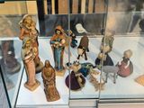 many figurines in a glass case on display
