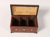 an old wooden box with three compartments sitting on top of a white surface