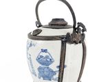 a blue and white tea pot with a handle