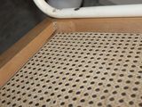 a close up of a chair with holes in the seat