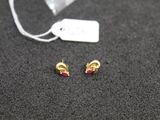 a small pair of earrings that are laying on a table