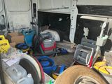 a van with a lot of clutter in the back of it