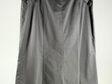 a black skirt hanging on a hanger against a white wall