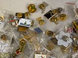 a pile of pins and other items on a table