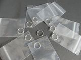 six clear bags with rings on them on a table