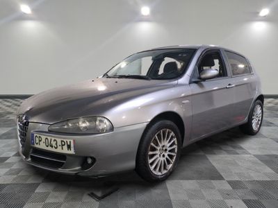 a silver car that is parked on a checkered floor