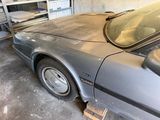 an image of a car in a garage that needs to be repaired
