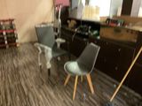 two chairs that are sitting in the middle of a room