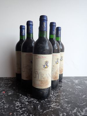 several bottles of wine are lined up on a table
