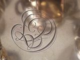 a silver plate with a monogram on it