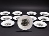 a lot of small white plates on a black table