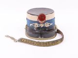 a hat with a chain around it on a white surface