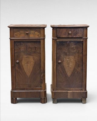 pair of antique wooden nightstands with a carved heart on the front
