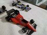 une petite voiture de course et deux autres petites voitures posées sur une table
