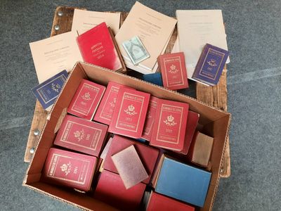 de nombreux livres dans une boîte en carton posée sur le sol