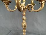 a gold candelab with two candles on it