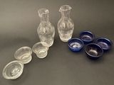 several glass vases and bowls sitting on a table