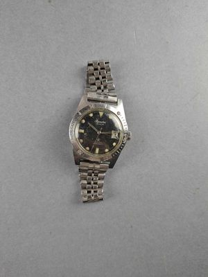 a close up of a watch on a table with a white background
