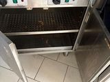 an oven with a door open on a tiled floor