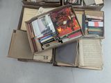 many books stacked on top of each other on the floor