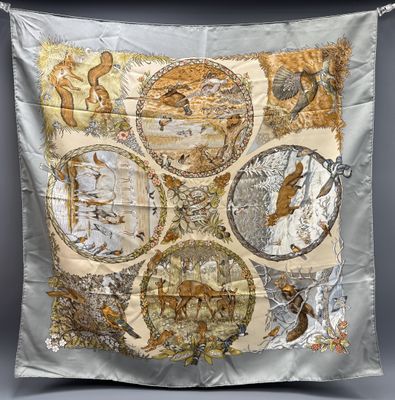 a close up of a piece of cloth with animals and birds on it