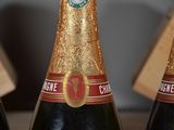 three bottles of champagne sitting next to each other on a table