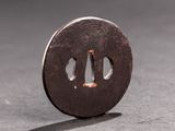 a small round metal object with a hole in it