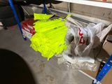 a pile of plastic bags on a shelf in a garage