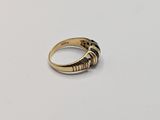 a close up of a gold ring on a white surface