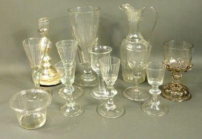 many glasses and vases sitting on a table