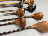 many different types of golf clubs lined up on a table