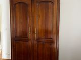 an image of a living room with a wooden armoire