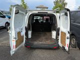a white van with its doors open in a parking lot