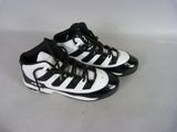a pair of black and white shoes on a white surface