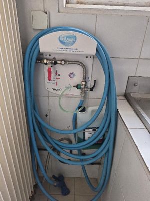 un tuyau bleu raccordé à un réservoir d'eau dans une salle de bains